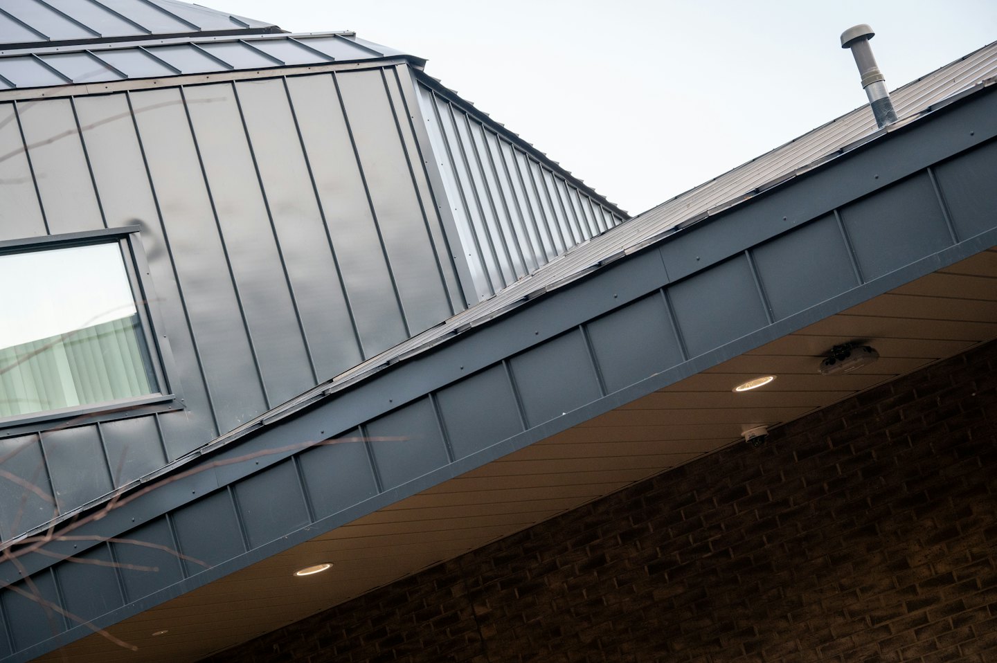 Modern building exterior with dark metal and brick details.