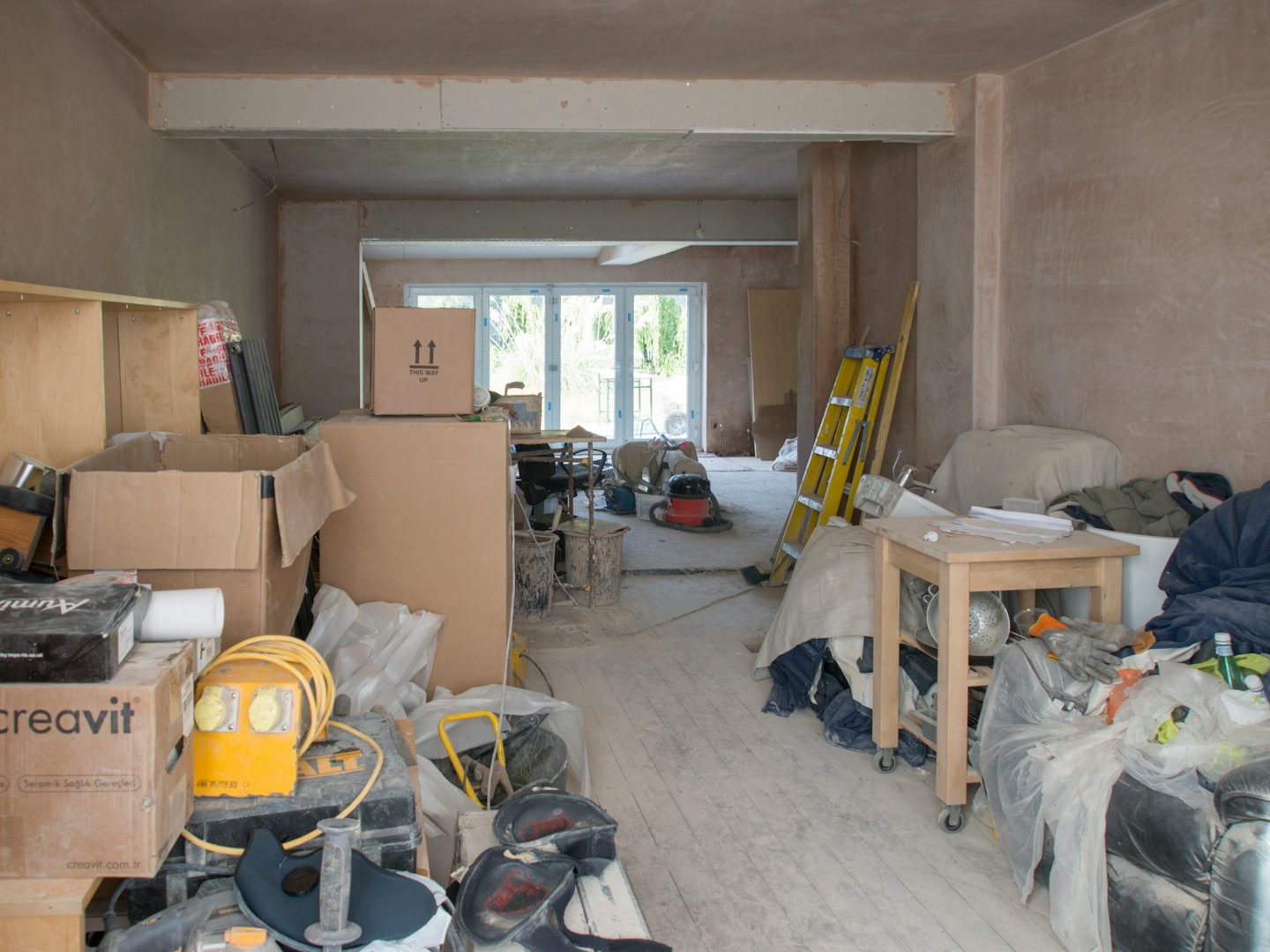 Renovating residential room filled with building materials and tools.