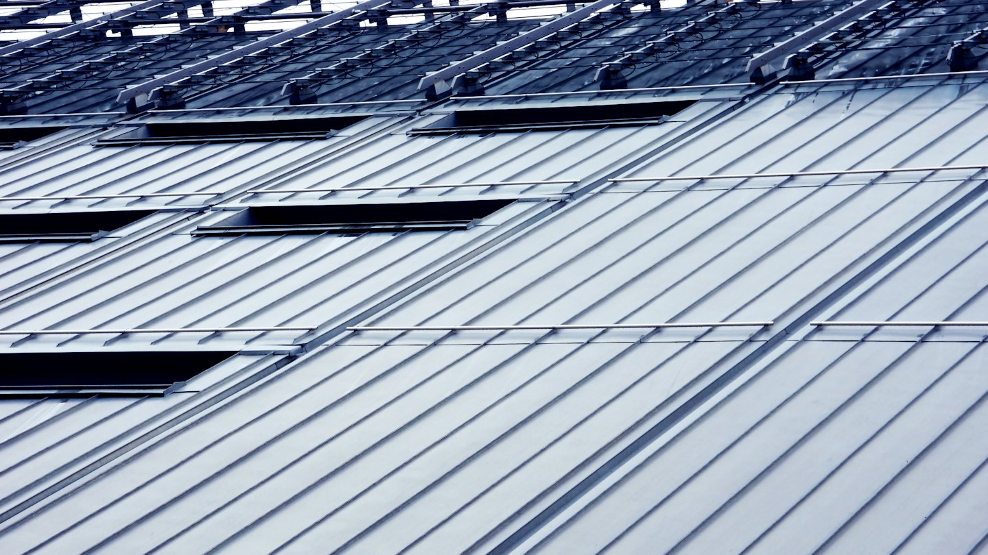 Modern metal roof with standing seams and skylights.